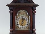 a wooden clock that is sitting on a table