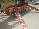 a crane that is sitting on the ground next to a truck