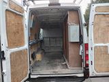 a white van with its doors open in a parking lot