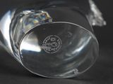 a close up of a glass vase on a black surface