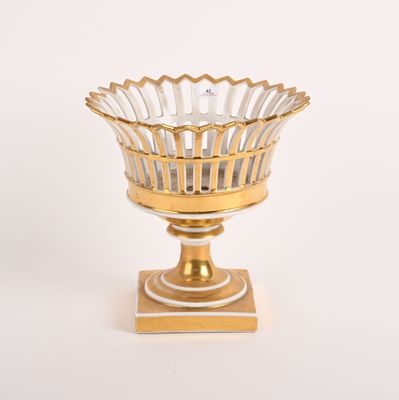 bol en verre doré et blanc posé sur un socle doré, sur fond blanc