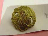 a picture of a gold brooch with a woman on it
