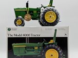 the model tractor is sitting on top of the box