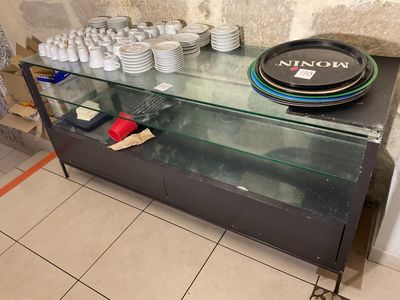 a glass display case with plates and cups on it