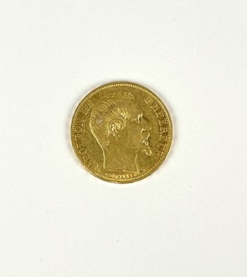 a close up of a gold coin on a white surface