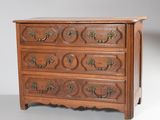 an antique chest of drawers with brass handles and a wooden top