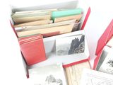 several books in a red box on a white surface