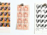 three prints on the wall of a white room