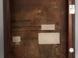 an old picture of a wooden frame with a piece of paper taped to it