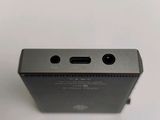 the back of a small black device on a white surface