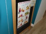 a menu board on the wall in the corner of the room