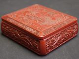 an orange box with carvings on it sitting on top of a table