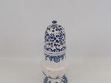 a small blue and white vase on a white table