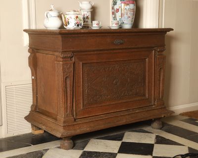 a wooden cabinet with a black and white checkered floor