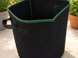 a close up of a black and green planter on a patio