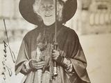 an old photo of a woman holding an umbrella