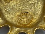 a close up of a gold plate with a train on it