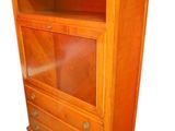 an image of a wooden bookcase with a glass door on top