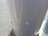 a white blender sitting on a pallet on the street