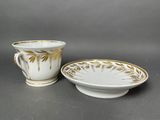 a close up of a cup and saucer on a table