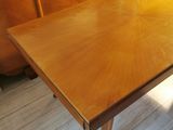 a wooden table with a wooden top and a wooden base
