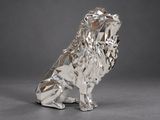a silver sculpture of a lion sitting on its hind legs