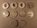 six different types of coins are shown in a row on a table