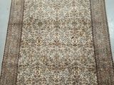 a large rug with a floral design on a white ground