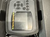an image of a fish finder sitting in a case on a table