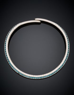 a necklace with turquoise and white stones on a black background