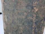 a stone statue with writing on it in a room