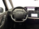 the interior of a car with a steering wheel and dashboard controls