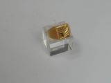 an image of a gold ring on a clear display case