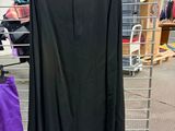 purple and black pants hanging on a rack in a clothing store