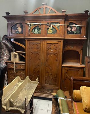 a large wooden cabinet in the middle of a room