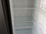 an empty refrigerator with the door open in a kitchen