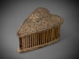 a small wooden comb that has a heart on it