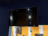 a flat screen tv mounted on the wall above a desk