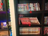 a book shelf with many dvds on it in a room