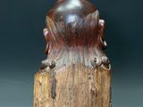 a close up of a wooden sculpture of a bear on a stump