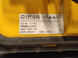 the back end of a yellow construction vehicle with a sticker on it ' s side