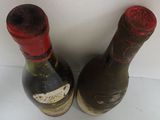 two bottles of wine sitting next to each other on a table