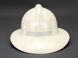 an old white fireman ' s hat on a black background