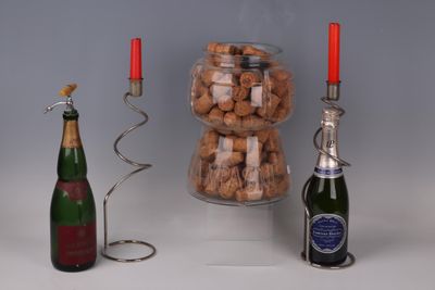bottles of wine and a candelab are sitting next to a candelab