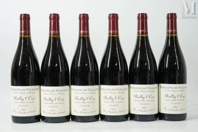 six bottles of wine are lined up on a white surface