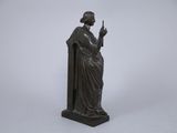 a bronze statue of a woman holding a cigarette in her hand