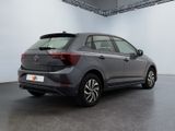 the rear end of a grey car in a white room