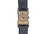 an image of a wrist watch with a gold dial and black leather strap