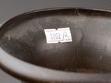 a close up of a brown vase with a sticker on it