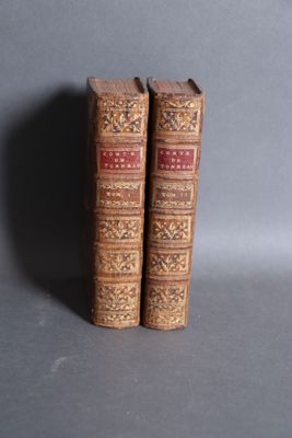 two old books that are sitting on a table
